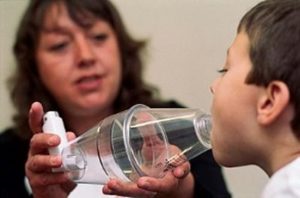 This image shows a spacer being used along with the inhaler