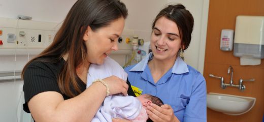 Nurse with patient holding a baby