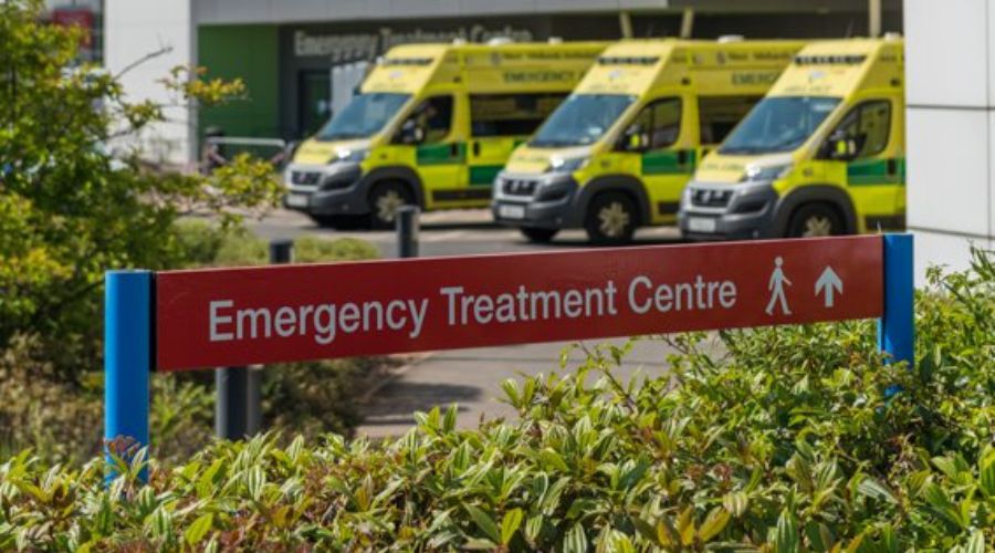 Suing post of Emergency Treatment Centre with ambulances in background